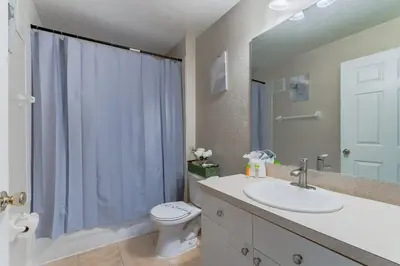 a bathroom with a sink and a toilet and a shower at Spacious 2BR Condo Near Disney with Pool & Basketball in Kissimmee