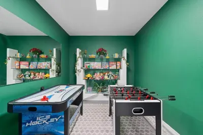 a childs play room with two foosball tables at [Popular Illusion Home] •Waterfront Private Pool in Kissimmee