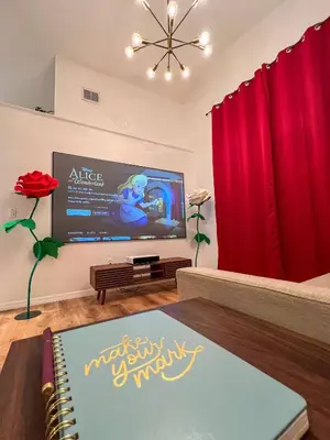 a living room with red curtains and a flat screen tv at [Popular Illusion Home] •Waterfront Private Pool in Kissimmee