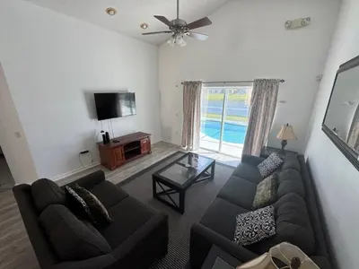 a living room with a couch and a tv at Ortega Villa home in Kissimmee