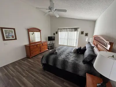 a bedroom with a bed and a ceiling fan at Ortega Villa home in Kissimmee