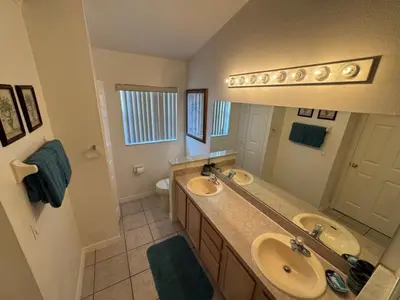 a bathroom with two sinks and a large mirror at Ortega Villa home in Kissimmee