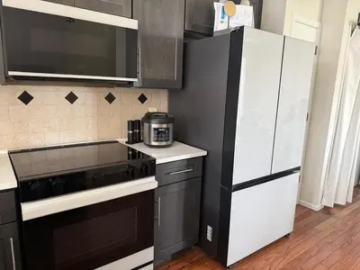 a kitchen with a black and white refrigerator at 3 bedroom home with private pool in Orlando