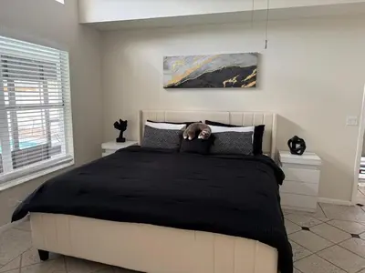 a bedroom with a bed with a teddy bear on it at 3 bedroom home with private pool in Orlando