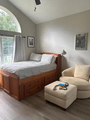 a bedroom with a bed and a couch and a chair at Cozy family house near Disney,epic and universal in Orlando