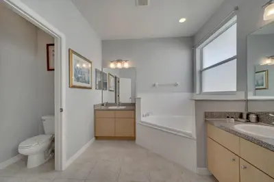 a bathroom with a tub and a toilet and a sink at Disney Getaway Pool Gated Resort Near Parks in Kissimmee