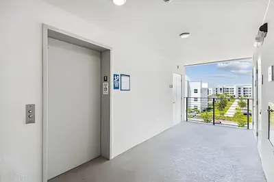 an empty corridor in an office building with a view of a city at Condo Luxo 3 Quartos | Storey Lake Resort in Kissimmee