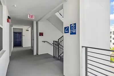 an empty hallway of a hospital with a blue door at Condo Luxo 3 Quartos | Storey Lake Resort in Kissimmee