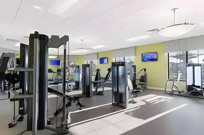a gym with rows of treadmills and machines at Condo Luxo 3 Quartos | Storey Lake Resort in Kissimmee