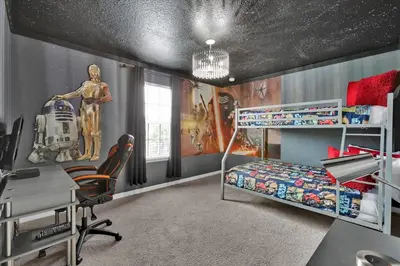 a bedroom with a bunk bed and a desk at Neverland Nook in Orlando