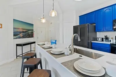a kitchen with blue cabinets and a white counter top at Moderno 3 Quartos no Vista Cay Resort in Orlando