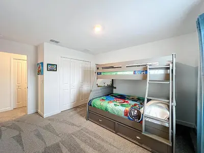 a bedroom with two bunk beds in a room at Luxury Pool Home Near Disney Resort Access in Kissimmee