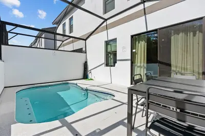 a swimming pool on the patio of a house at 2026 Luxury 5Bedrooms At Paradiso Grande in Orlando