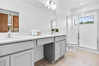 a white bathroom with a sink and a toilet at 2026 Luxury 5Bedrooms At Paradiso Grande in Orlando
