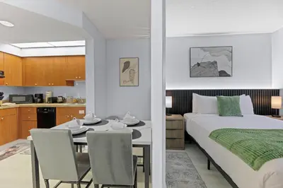 a bedroom with a bed and a table and chairs at Orlando 2BR Apt Full Kitchen Epic Universe in Orlando