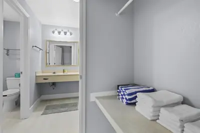 a bathroom with a sink and a toilet and a mirror at Orlando 2BR Apt Full Kitchen Epic Universe in Orlando