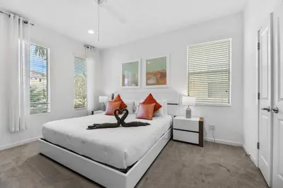a bedroom with a bed with a swan statue on it at Pool 4BR Resort Home Near Disney in Kissimmee