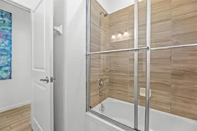 a shower with a glass door in a bathroom at Pool 4BR Resort Home Near Disney in Kissimmee