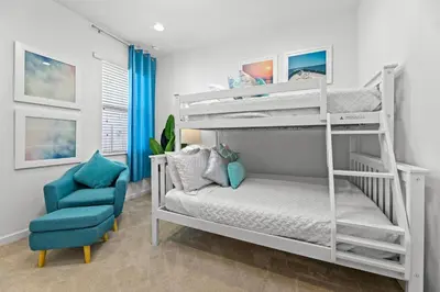 a bedroom with two bunk beds and a blue chair at Pool 4BR Resort Home Near Disney in Kissimmee