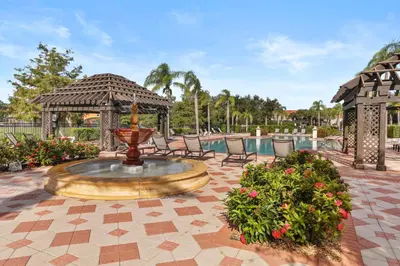 a fountain in a patio with chairs and a gazebo at Pool 4BR Resort Home Near Disney in Kissimmee