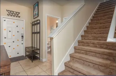 a staircase in a home with a white door at Disney & Resort Fun Private Pool Renovated in Kissimmee
