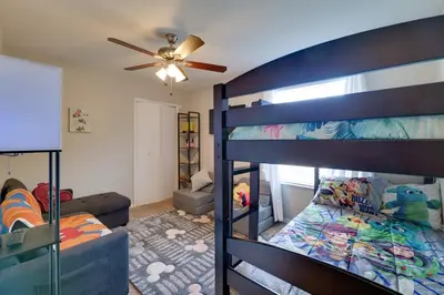 a bedroom with two bunk beds and a ceiling fan at 5 Mi to WDW Resort-Style Condo with Pool Access in Kissimmee