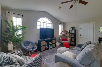 a living room with couches and a flat screen tv at 5 Mi to WDW Resort-Style Condo with Pool Access in Kissimmee