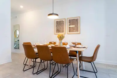 a dining room with a table and chairs at Stylish & Fun Retreat Pool Themed Rooms in Kissimmee