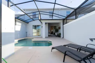a swimming pool in a house with a glass ceiling at Stylish & Fun Retreat Pool Themed Rooms in Kissimmee