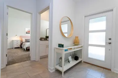 a white room with a bed and a mirror at Stylish & Fun Retreat Pool Themed Rooms in Kissimmee