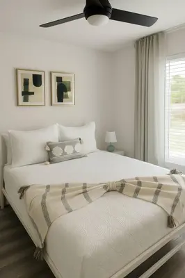 a bedroom with a large bed with a ceiling fan at Once upon a good stay - 7 Beds Pool Home by Disney in Kissimmee
