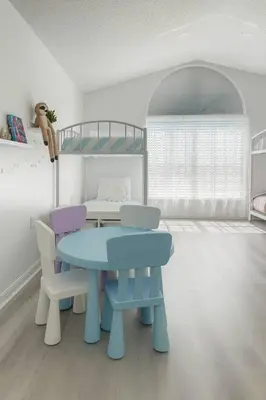 a room with a table and two chairs and a bunk bed at Once upon a good stay - 7 Beds Pool Home by Disney in Kissimmee
