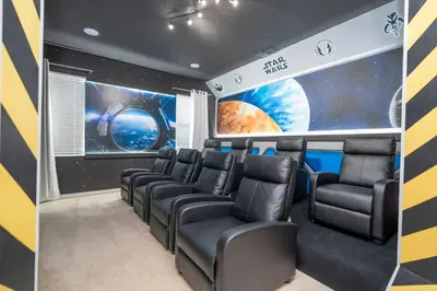 a room with chairs and an astronomy mural at 12BR Home w Game Room Movie Theater in Kissimmee