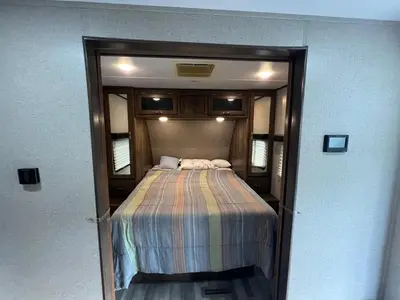 a bedroom with a bed in a small room at Beautiful RV 15 Min to Downtown Orlando in Orlando