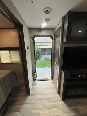 a room with a bedroom and a tv at Beautiful RV 15 Min to Downtown Orlando in Orlando