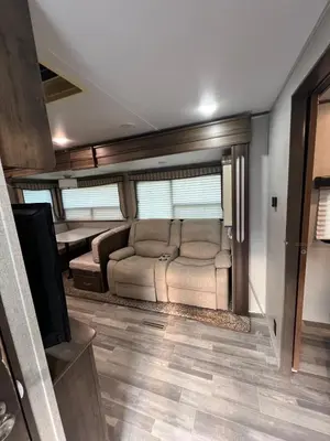a living room with a couch and a tv at Beautiful RV 15 Min to Downtown Orlando in Orlando