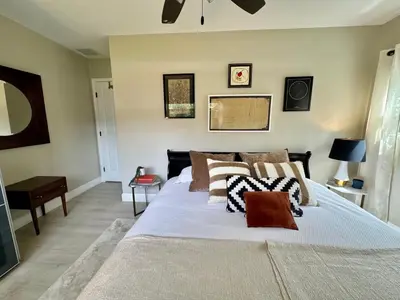 a bedroom with a bed with pillows on it at Chic & Stylish 3BR-2BA Nature Lovers Home in Orlando