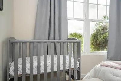 a baby crib in a room with a window at New Vacay Home 5BD 5BA - 5 miles to Disney in Orlando