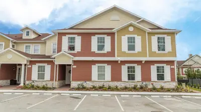 a house in a parking lot at New Vacay Home 5BD 5BA - 5 miles to Disney in Orlando