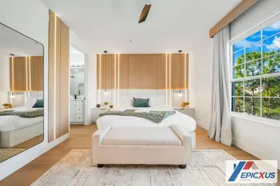 a bedroom with a bed and a chair and a window at The Epic New Jersey Vista Cay in Orlando
