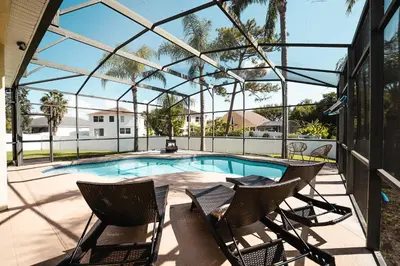 a patio with chairs and a swimming pool at Serenity in the sun in Kissimmee