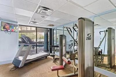 a gym with treadmills and ellipticals in a building at Apartamento Moderno 2 Quartos no Enclave in Orlando