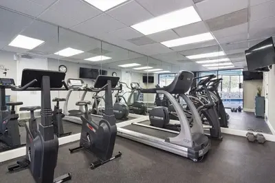a gym with treadmills and elliptical machines at Apartamento Moderno 2 Quartos no Enclave in Orlando