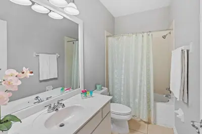 a white bathroom with a sink and a toilet at Townhouse 3 suítes no Vista Cay Resort in Orlando