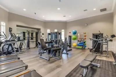 a gym with treadmills and machines in a room at Townhouse 3 suítes no Vista Cay Resort in Orlando