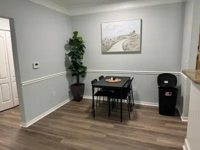 a dining room with a table and a plant at Bellavue Getaway in Kissimmee