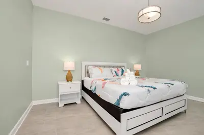 a white bedroom with a bed with a stuffed animal on it at Last Minute Disney Private Pool Hot Tub Game Room Themed Bedrooms. Book Now SLR551 in Kissimmee