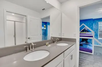 a bathroom with two sinks and a bunk bed at Last Minute Disney Private Pool Hot Tub Game Room Themed Bedrooms. Book Now SLR551 in Kissimmee