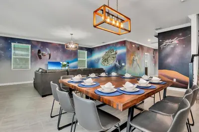 a dining room with a wooden table and chairs at Last Minute Disney Private Pool Hot Tub Game Room Themed Bedrooms. Book Now SLR551 in Kissimmee