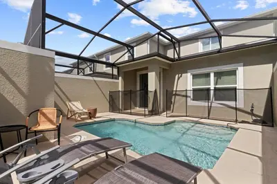 a swimming pool in the middle of a house at Last Minute Disney Luxury Townhouse with Private Pool. Book Now SLR557 in Kissimmee